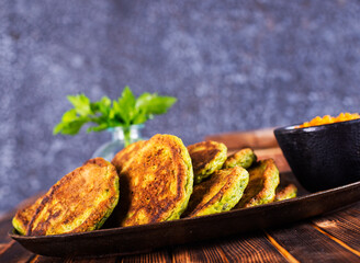 Green zucchini fritters, vegetarian zucchini pancakes with fresh herbs and garlic