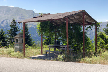 Fototapeta premium Wooden gazebo in the mountains near the mountain road (Central Greece)