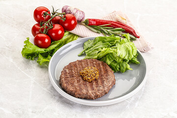 Frilled beef burger cutlet with iceberg