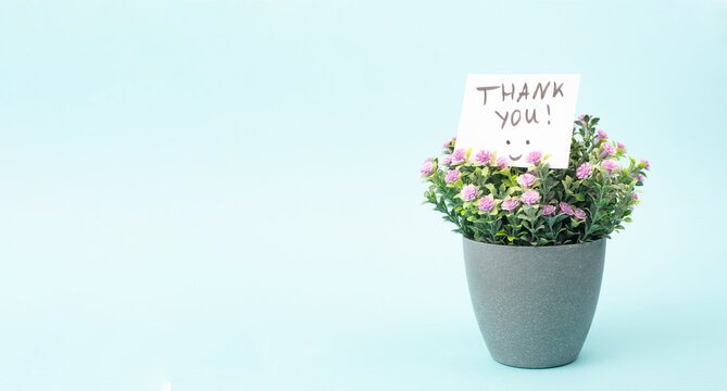 Thank you card with flowers and a happy smiling face, being thankful, support, help and charity concept, positive attitude 
