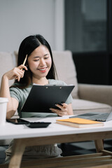 lifestyle of office workers Woman calculating expenses and using laptop. Home office. Work place. Lifestyle.