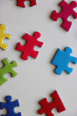 Colorful jigsaw puzzle pieces on white background. Flat lay.