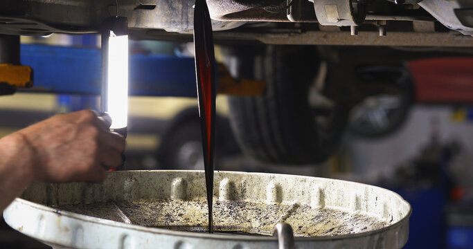 The process of draining old used motor oil at a service station