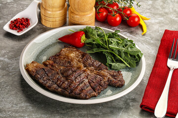 Grilled chuck roll steak with arugula
