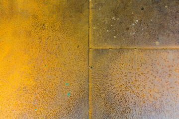 A close-up of a rusted metal surface, Yellow rusty metal texture background.