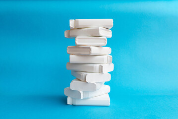 Pharmaceutical stacked up supplement plastic boxes on blue background.