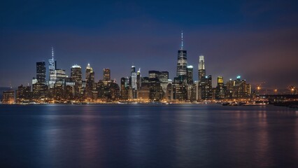 Obraz premium Glowing City Skyline Reflecting on Water at Night