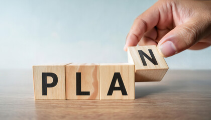 Naklejka premium A hand is holding a wooden block with the word 