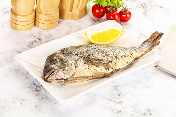 Baked Dorado fish served lemon