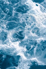 Fototapeta premium The image is of a body of water with a lot of foam and bubbles. The water appears to be very cold and the foam is very thick. Scene is calm and peaceful, as the water seems to be still