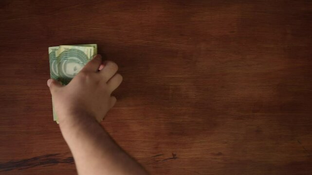 Concept of investment, money exchange, bribes or corruption. Stacks of one hundred thousand guaran&iacute;es PYG
