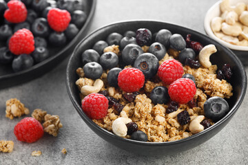 Dry granola with blueberries and raspberries. Healthy breakfast meal