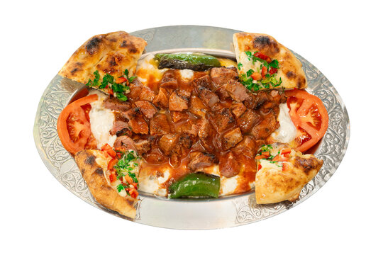 Top view Ali Nazik Kebab, Traditional Turkish Lamb Kebab with Spicy Smoked Eggplant and Yogurt on a traditional serving platter. Turkish name; Ali nazik kebab, isolated on a white background