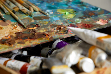 Oil paints palette and paint brushes