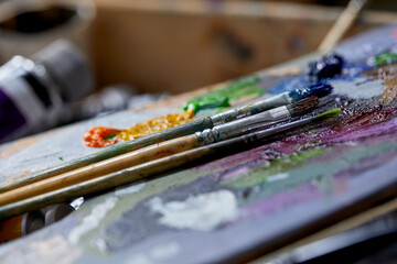 Oil paints palette and paint brushes