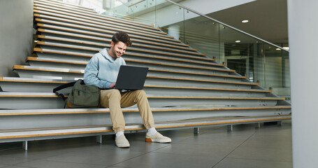 Man, stairs and student on laptop for learning, assignment and books for studying on campus. Male...