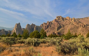 eroded  volcanic rock formations and dramatic cliffs on a sunny summer day  in the high desert of smith rock state park, near bend,  in central oregon