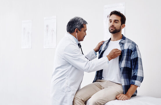 Men, doctor and patient with stethoscope for checkup, consultation and healthcare at hospital. People, medical practitioner and clinic for exam, help and support with help for heart rate and recovery