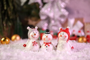 Different funny snowmen figures on artificial snow