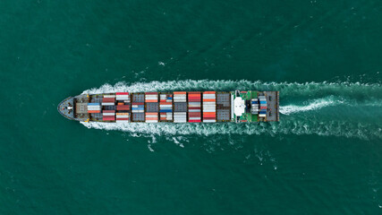 logistic cargo container ship sailing in sea to import export goods and distributing products to dealer and consumers across worldwide, by container ship Transport business service.