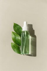 Transparent Cosmetic spray bottle with green leaf for skin care. Beauty product mockup for natural...