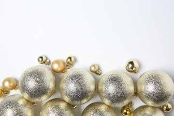 Christmas decor. Different shiny baubles on white background, flat lay. Space for text