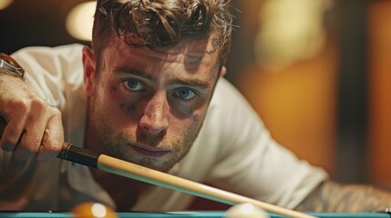 A man in a white t-shirt, ready to shoot pool in a serious atmosphere. Dim lighting adds solemnity. No mention of black eye or singed eyebrows included.
