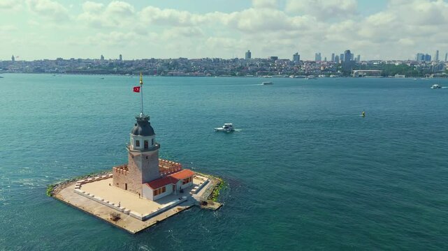 View a lighthouse with a flag on.