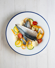 Baked mackerel with delicious and healthy vegetables. Top view table.