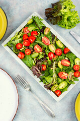 Fresh lettuce leaves and tomato salad.