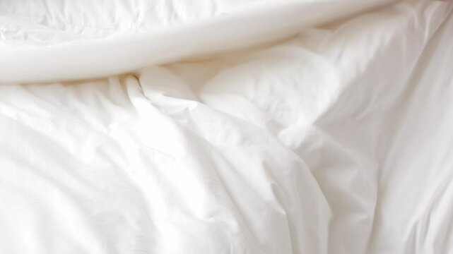 view to linen white bed while a man housekeeping cleaning bed make up bed blanket and pillow in morning time in bedroom of hotel resort, made up bedroom in resort hotel