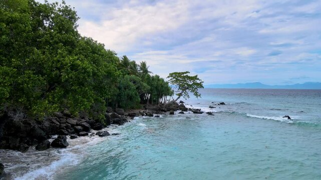 Aerial Footage of Sea Water Splashing Against Rocky Beach
