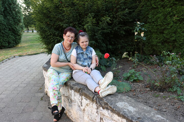 Fototapeta premium A mother walks with her daughter with Down syndrome.