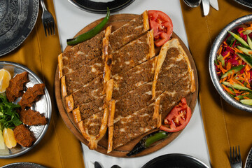 Top view, traditional Turkish cuisine and table setting, traditional pide, food service, appetizers and dishes.