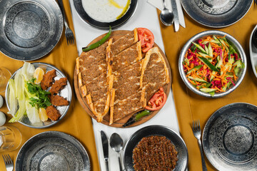 Top view, traditional Turkish cuisine and table setting, traditional pide, food service, appetizers and dishes.