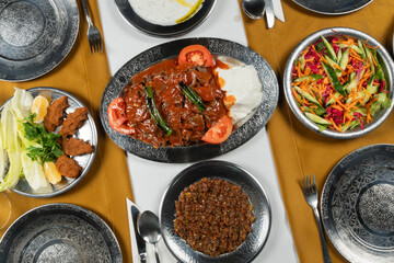 Top view, traditional Turkish cuisine and table setting, doner kebab with sauce and yogurt, food service, appetizers and dishes.