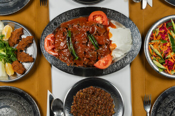Top view, traditional Turkish cuisine and table setting, doner kebab with sauce and yogurt, food...