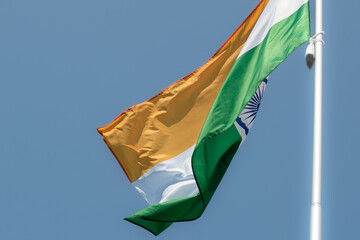 Flag of India fluttering against blue sky. Flag of India, national symbol of India. Flag of India...