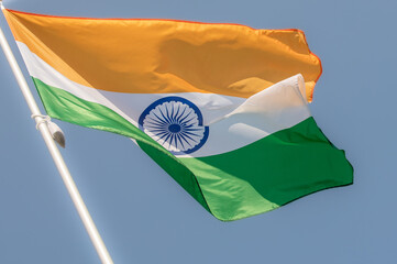 Flag of India fluttering against blue sky. Flag of India, national symbol of India. Flag of India...