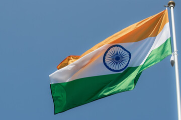 Flag of India fluttering against blue sky. Flag of India, national symbol of India. Flag of India...