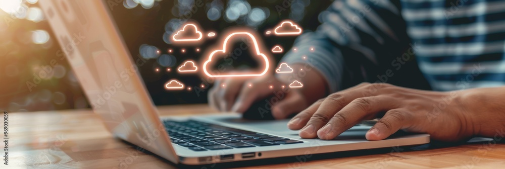 Aufkleber hands working on laptop with glowing cloud icons, concept of cloud computing and data storage
