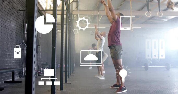 Animation of business icons over diverse people exercising with balls at gym - Powered by Adobe