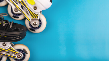 Stylish roller skates on blue background, top view. Inline skates isolated on blue, extreme sports...