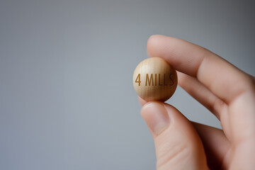 A hand holding the &euro;4 million wooden ball from the Spanish state Christmas lottery
