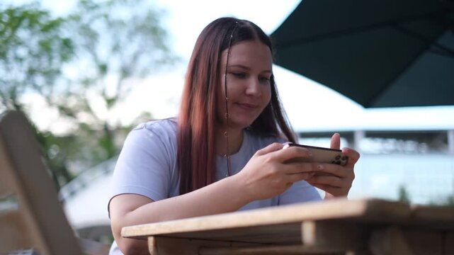 portrait of a plump woman playing racing on a smartphone