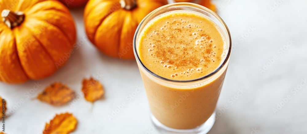 Aufkleber close up of a healthy pumpkin spice smoothie alongside pumpkins on a white background. with copy spa