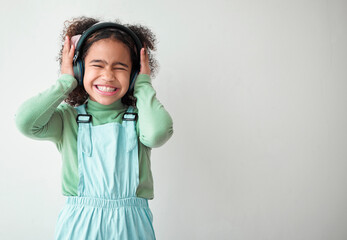 Excited, girl and kid with headphones, cover ears and streaming music on white studio background....