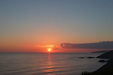 Obraz premium Tranquil Sunset Colors Over the Ocean with Serene Coastal Scenery