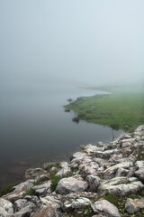 Trekking in foggy and rainy weather in spring. View of the plateau in foggy weather. Water channels on the plateau in foggy weather.
