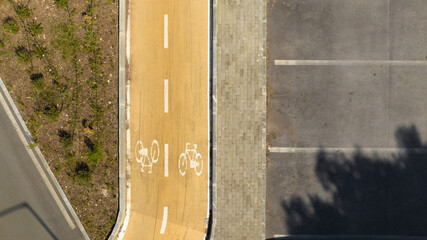 Aerial zenithal view of a yellow cycle path.